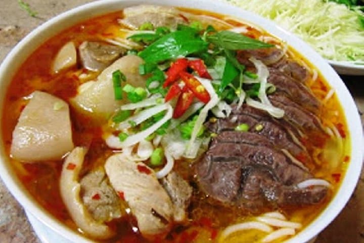 Hue: Night Street Food Tour by E Bike with a Lady Rider