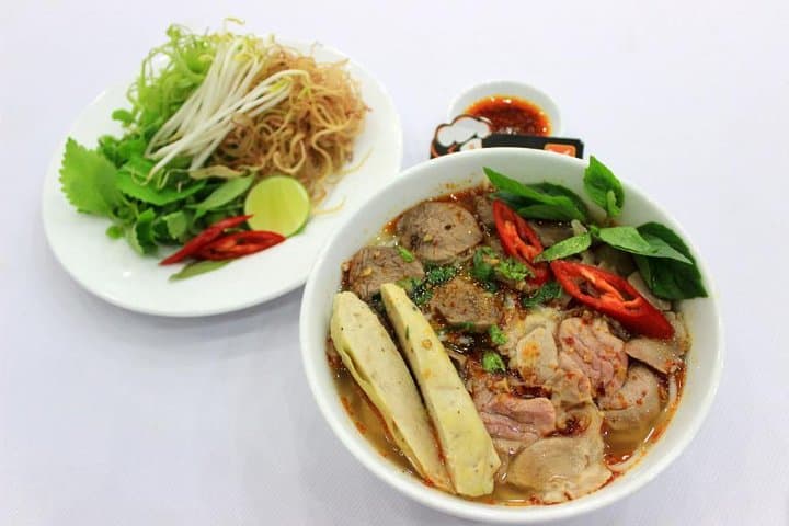Hue: Night Street Food Tour by E Bike with a Lady Rider